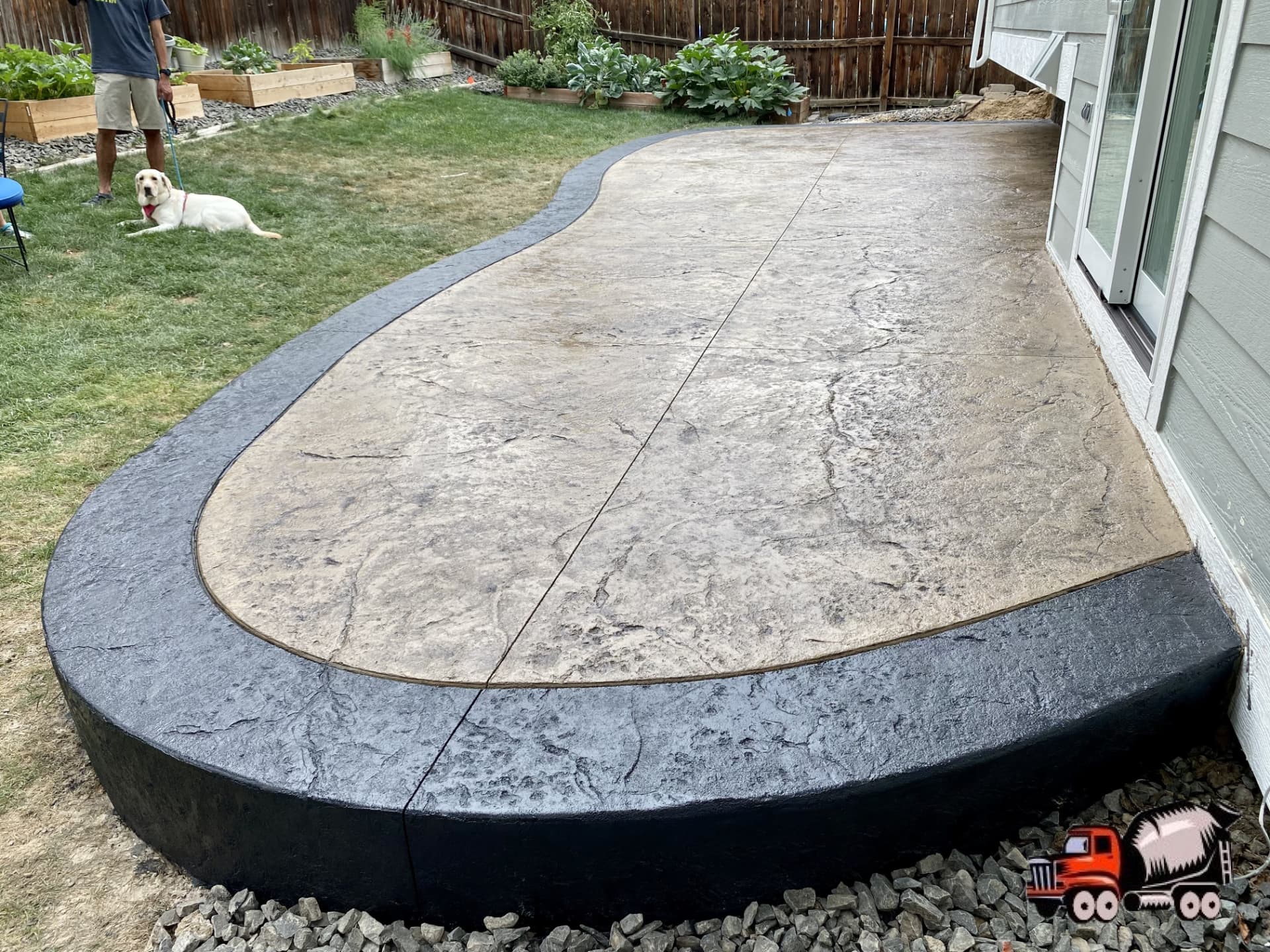 Stamped concrete patio with charcoal border poured by Tucker Built Co